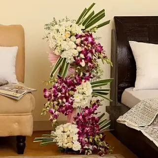 4 feet height arrangement of white 50 carnations,with 50 white daisies,and 30 Purple orchids 