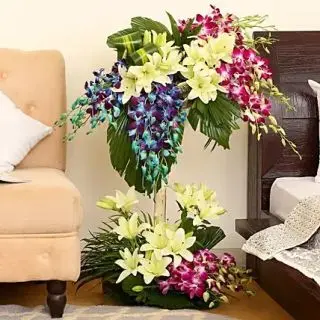 4 feet height exclusive  arrangement of 40 blue and purple orchids,15 white lilies 