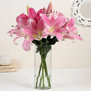 7 pink lilies arranged in vase