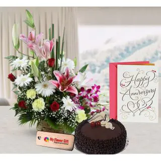 Exclusive basket arrangement of exotic mix flowers , 1 kg chocolate truffle cake with anniversary card 