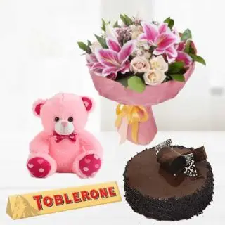 Bunch of exotic mix flowers with 6 inch pink teddybear with toblerone chocolates with chocolate truffle cake 