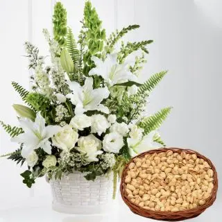 Exotic basket arrangement of lilies and roses with Basket of  half kg pistachio