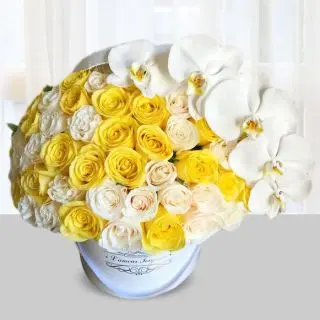 Box arrangement of 30 yellow and white roses with calla lilies