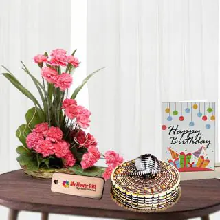 Basket arrangement of 20 pink carnations, half kg butterscotch cake with birthday card