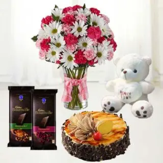Beautiful Arrangement of mix flowers in glass vase with irish coffee cake with 1 feet height cute teddybear with pair of bournville dark chocolates 