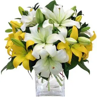 6 yellow and white lilies arranged in glass vase