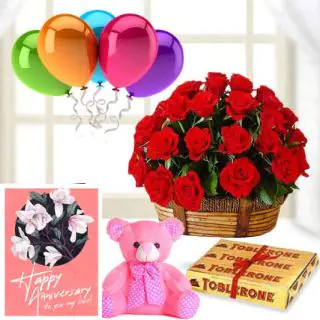 15 red roses basket, 3 toblerone chocolates, 6 inch pink teddybear, anniversary Greeting card with 5 blown balloons 