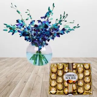 8 blue orchids arranged in glass vase with box of 24 pcs rocher ferrero chocolates 