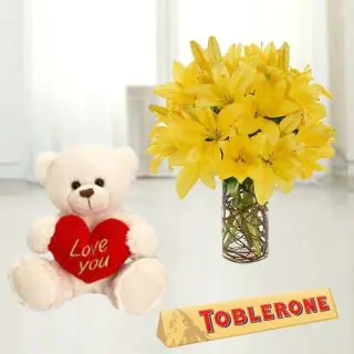  Beautiful vase arrangement of yellow lilies with toblerone chocolate & 6 inch teddy bear 