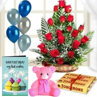 Basket of 20 red roses, 6 inch teddybear,3 toblerone chocolates, birthday Greeting card with 5 blown balloons 