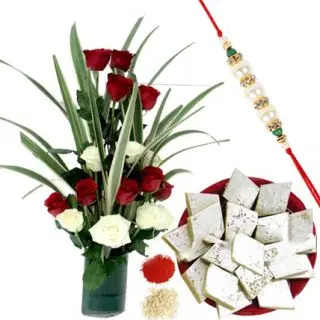 A beautiful vase arrangement of 20 red and white roses with 1 kg kaju katli with roli chawal
