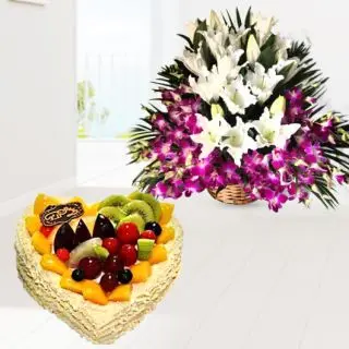Basket arrangement of 10 purple orchids with 5 white lilies with mix fruit cool cake 