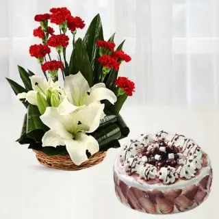 Basket arrangement of 10 red carnations with 2 white lilies with choco chips cool cake 