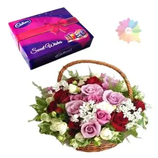 Basket arrangement of 15 mix colour roses with box of cadburys celebration