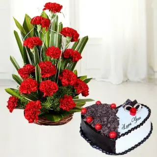 Basket arrangement of 20 red carnations with  heart shape black forest cool cake 