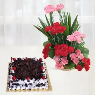 basket arrangement of 30 pink and red carnations with square shape black forest cake 