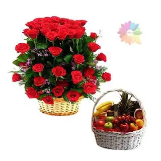 Basket arrangement of 50 red roses with 2 kg seasonal fruits basket
