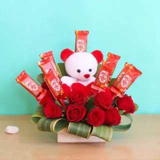 Basket Arrangement of 8 red roses, 6 inch teddybear, 10 kitkat
