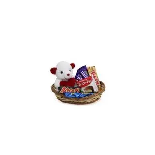 basket arrangement of a cute teddy bear with assorted chocolates