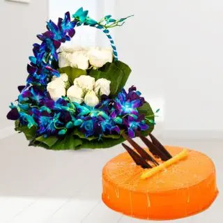 Basket arrangement of blue orchids with white roses with orange cool cake 