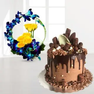 Basket arrangement of blue orchids with yellow roses with chocolate explosion cake 