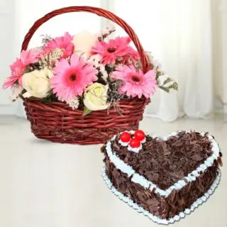 Basket arrangement of pink gerberas with white roses with black forest heart shape cake 