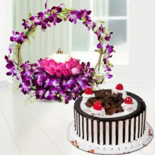 Basket arrangement of purple orchids with pink and white roses with black forest cool cake 