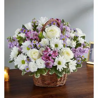 Basket arrangement of white orchids, white roses with white daisies 