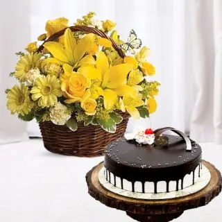 Basket arrangement of yellow gerberas, lilies, roses with choco vanilla cool cake 