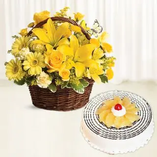 Basket arrangement of yellow lilies with yellow roses with pineapple cake 