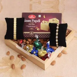 Basket of 250 grams almond , half kg soan papdi, set of 2 rakhi 