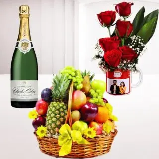Basket of 3 kg assorted fruits, Bottle of champagne with 5 red roses arranged in photo mug 