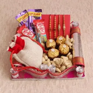 Basket of 4 rakhis, half kg cashew, 4 pcs rocher ferrero chocolates, 4 assorted chocolateswith raksha bandhan card 