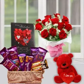 Basket of assorted silk cadburies & 5star chocolates, 6 inch red teddybear, 10 red roses bunch with greeting card 