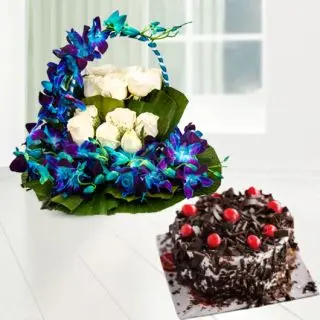 Basket of blue orchids with white roses with black forest cake 