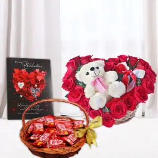 Basket of kit kat chocolates, valentine day greeting card, with heart shape arrangement of 20 red roses with teddy bear sitting in it  