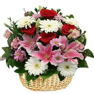 Basket of mix flowers with gerberas, lilies, roses in different colours