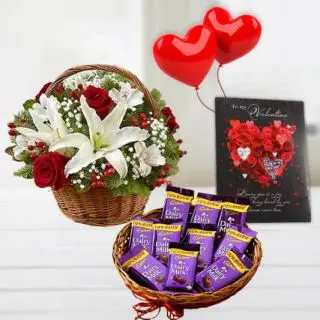 basket of red roses with white lilies, 2 heart shape balloons , valentine day card basket of dairy milk chocolates 