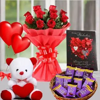 Beautiful Bouquet of 10 red roses with basket of dairy milk chocolates with 6 inch teddybear with valentine day greeting card with pair of heart shape balloons 