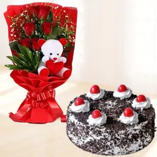 Beautiful bouquet of 6 red roses with 6 inch teddy bear sitting in it with black forest cool cake