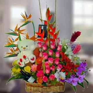 Beautiful floral arrangement of exotic flowers including bird of paradise, ginger lilies, oriental lilies , dutch roses with cute teddy 8 inch teddy