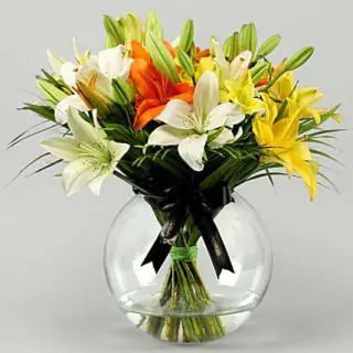 Beautiful glass bowl arrangement of 10 mix colour lilies 