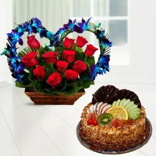 Beautiful heart shape basket arrangement of blue orchids with red roses with butterscotch fruit cake 