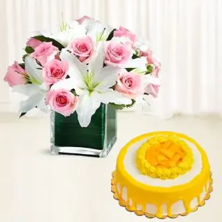 Beautiful Vase arrangement of pink roses with white lilies with mango cool cake 