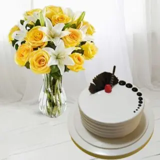 Beautiful vase arrangement of yellow roses with white lilies with half kg vanilla cool cake 