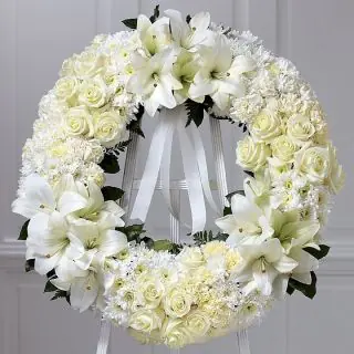Beautiful Wreath of white exotic lilies with white dairy, white carnations and white roses 