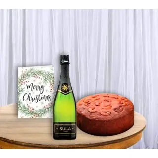 Bottle of wine, chocolate plum cake, with christmas greeting card 