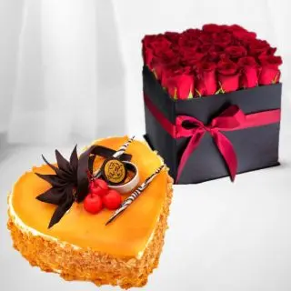 Box arrangement of 20 red roses with heart shape mango premium quality cake 