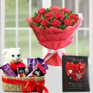 bunch of 10 red carnations, basket of assorted chocolates with teddy bear sitting in it, with valentine card 