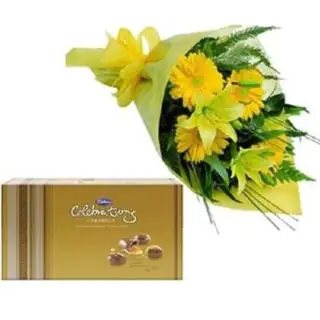bunch of lilies and gerberas with box of celebration